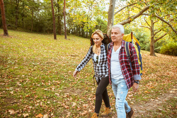 istock Middle aged couple hiking with backpacks 1285184114