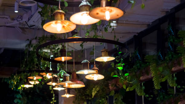 istock several round pendant retro loft style lanterns with edison bulbs shine with warm light in interior of dark restaurant, closeup of hanging lamps, nobody. loft-style restaurant with lighting fixtures. 1285185005