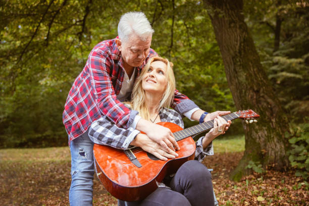 istock Beautiful middle aged couple enjoying on camping in nature 1285186637