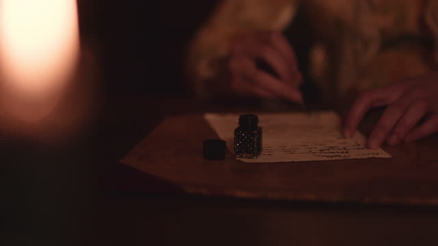 Quill and ink by candle light.