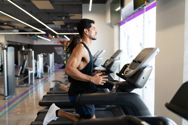 istock Profile of a fit latin man running on a treadmill 1285187366
