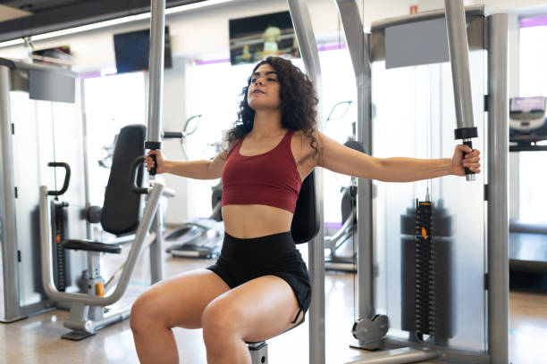 istock Beautiful woman working out her back in a gym machine 1285187556