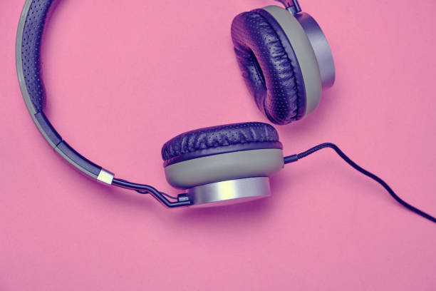istock Wired headphones in khaki on a pink background. 1285188416