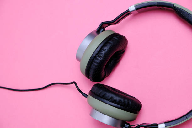 istock Wired headphones in khaki on a pink background. 1285188418