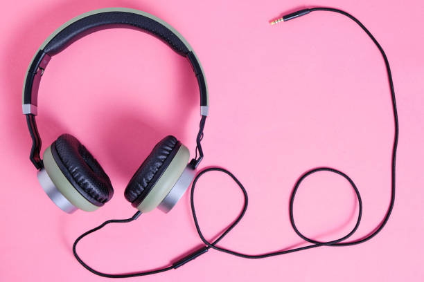 istock Wired headphones in khaki on a pink background. 1285188423