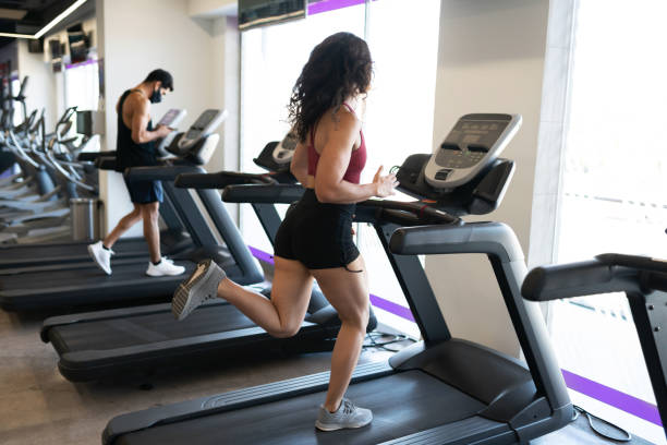 istock Athletic woman in her 20s running on a machine 1285189795