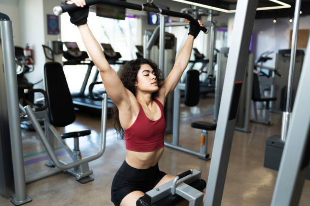 istock Active woman lifting weights at the gym 1285189826