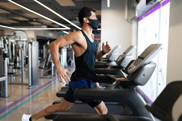 istock Strong young latin man focused on running in a treadmill 1285189831