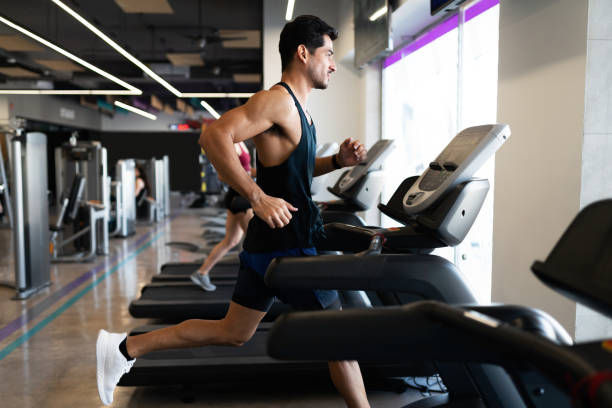 istock Focused young man on a treadmill in the gym 1285189836