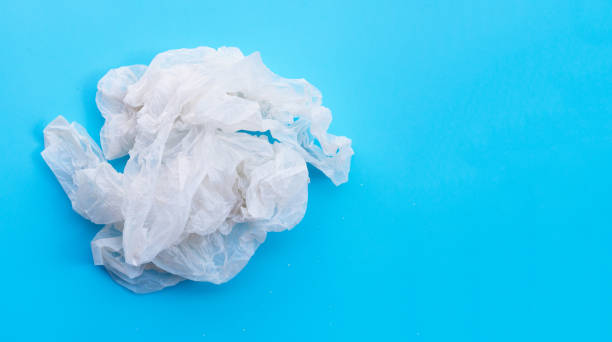 istock Crumpled plastic bags on blue background. Copy space 1285195695