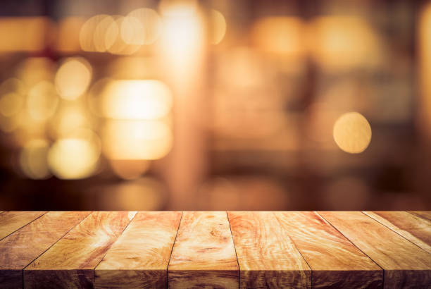 istock Wood table top (bar) with blur light bokeh in dark night cafe,restaurant background 1285205234