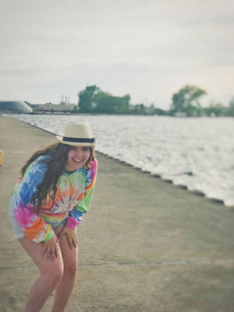 istock Hipster posing, wearing tie-dye and having fun on a pier on Lake Michigan. 1285207015