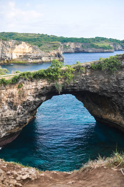 istock Natural bridge over shallow water 1285209243