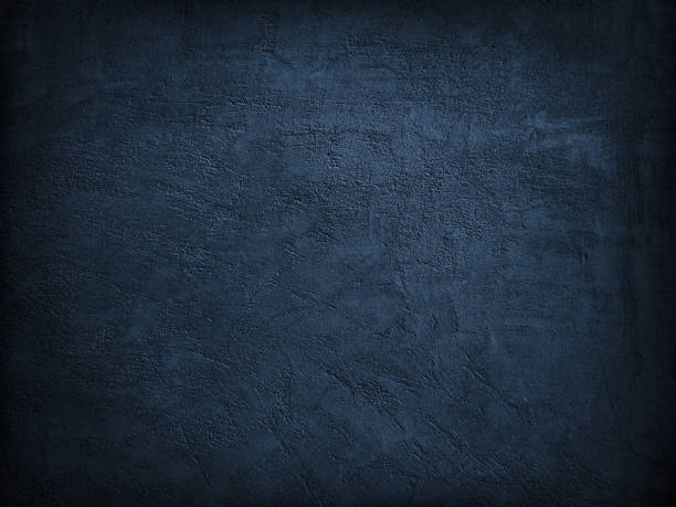 istock Dark blue grunge background. Texture of a plastered concrete wall. Black abstract background. Navy blue grainy rough surface texture. 1285212050