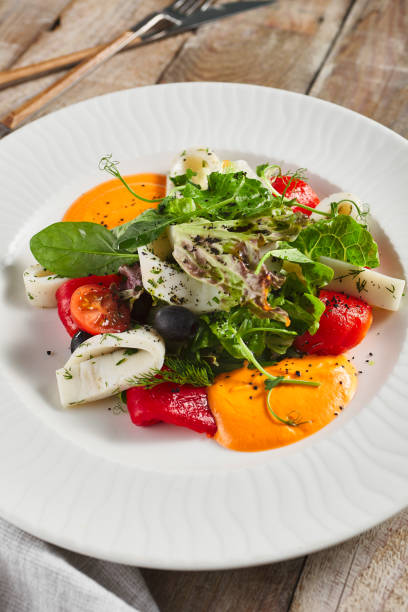 istock Roasted pepper salad with calamari and fresh greens 1285212968