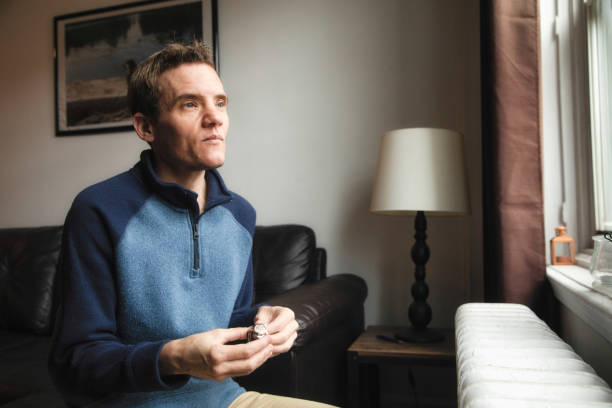 istock Autistic trans man at home looking out of a window pensively 1285213982