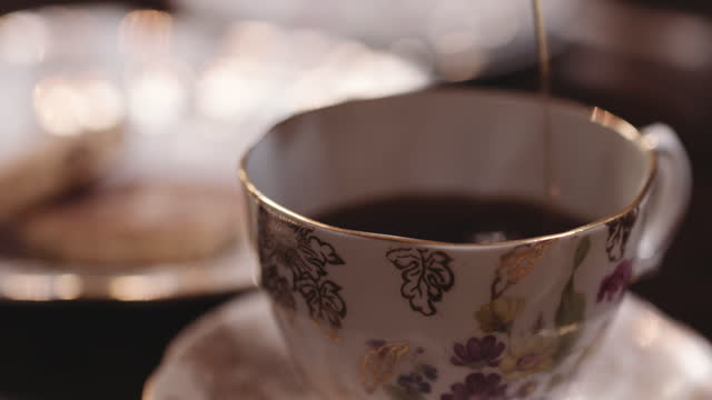 Tea poured into decorative cup.