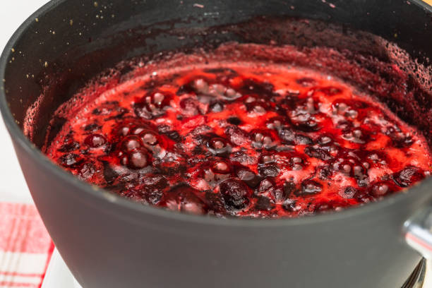 istock Cranberry sauce being heated up in a pan, close up view, selective focus. Cooking process, cranberry sauce recipe 1285215026