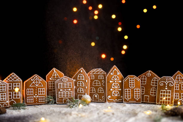 istock Winter gingerbread house with light from the windows, gingerbread city, big side lights, snow. New Year's content. 1285215704