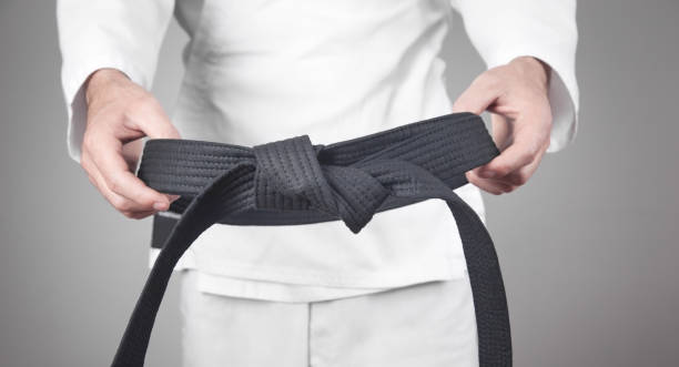 istock Caucasian man holding his black belt. 1285220155