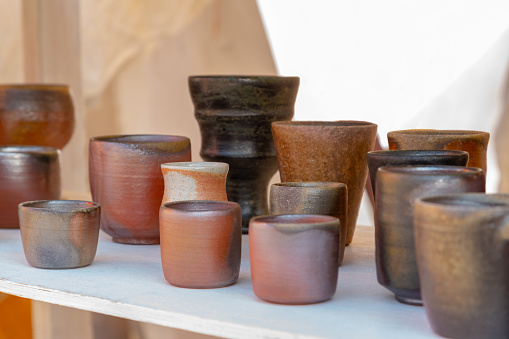 Display of hand made clay cup for tea or coffee at ethnic souvenir fair
