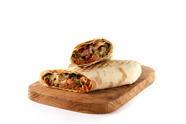 istock shawarma, roll in lavash , grilled meat, with vegetables, sandwich , cut on a white background, horizontal, copy spase 1285224126