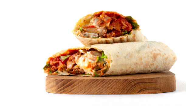 istock shawarma, roll in lavash , grilled meat, with vegetables, sandwich , cut on a white background, horizontal, copy spase 1285224873