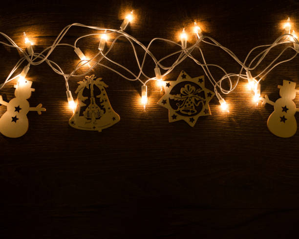 istock Christmas magic lights on a wooden background 1285226413