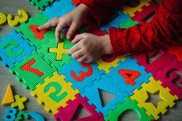 istock little girl playing with puzzle, education concept 1285227653