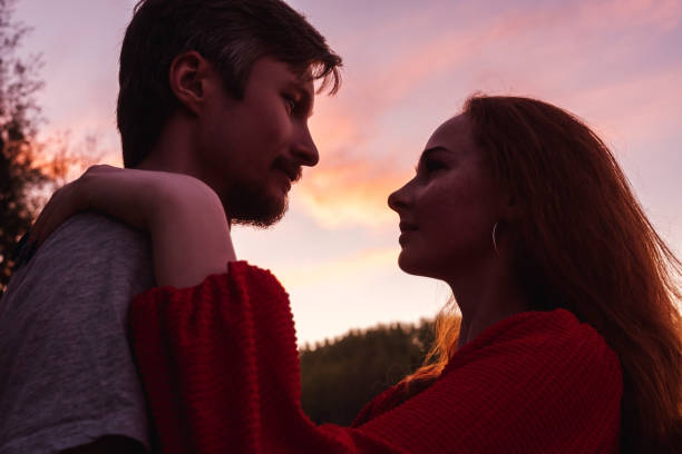 istock Man and woman silhouettes on sky background. 1285227778