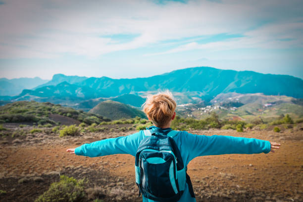 happy young boy enjoy hiking in mountains, travel concept