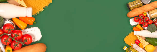 istock Banner with different groceries, food donations on green background with copyspace - pasta, fresh vegatables, canned food, cooking oil, tomatoes, cheese, milk. Food bank, food delivery concept 1285231608