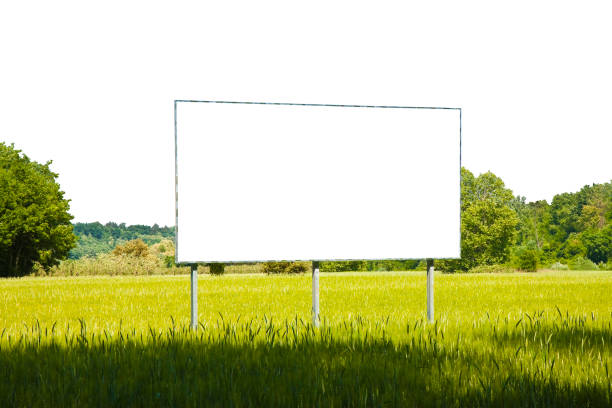 istock A blank advertising billboard in a grass field - image with copy space on white background for easy selection 1285236392