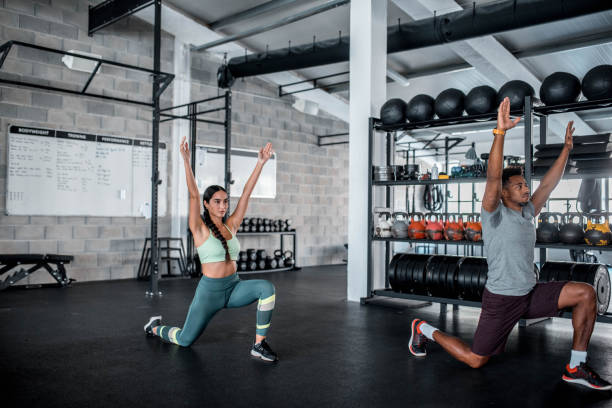 istock Multi Ethnic Group Of People Warming Up Before Cross Training In The Gym 1285236992