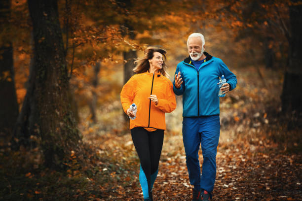 istock Mature couple jogging in a forest. 1285238341