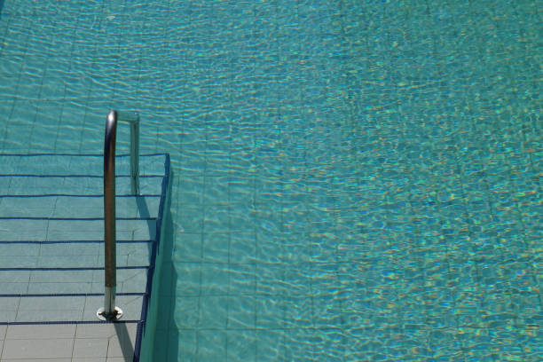 istock fragment of the pool with a ladder close up 1285238420