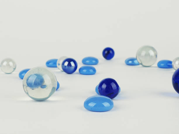 istock blue balls on white background, abstract background scattered glass balls 1285240515