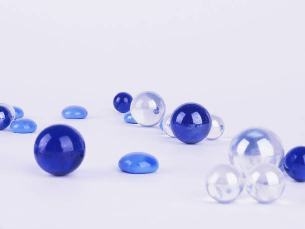 istock blue balls on white background, abstract background scattered glass balls 1285240521