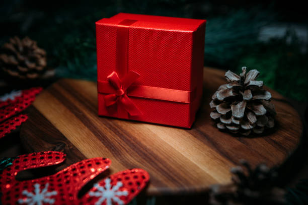 istock Red Gift Box Next To Pine Cone .Christmas Background With Copy Space 1285242139