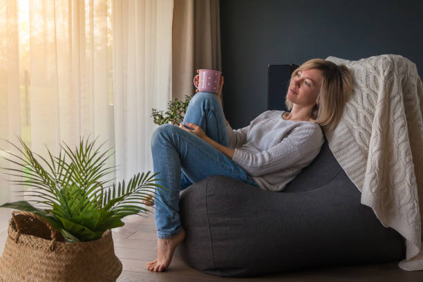 istock Relaxed woman on a bean bag chair 1285243526