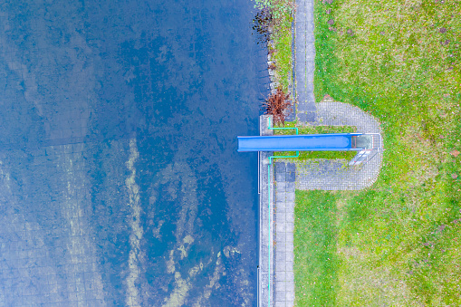 an old swimming pool with a slide from above