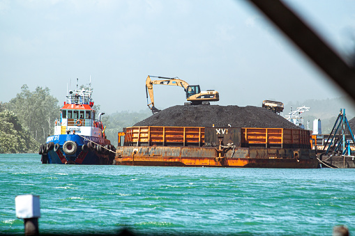 view of a barge loading coal at the Mahakam river port in Samarinda, East Kalimantan 28 January 2016