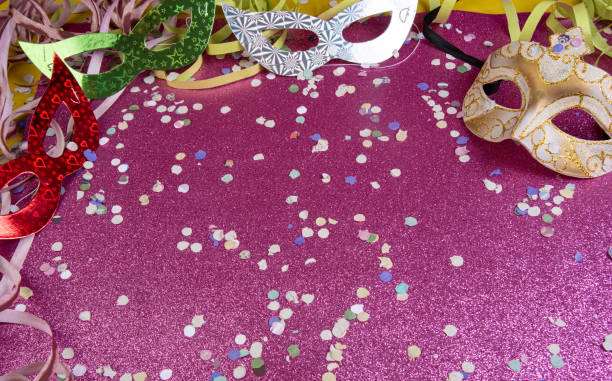 istock Brazilian carnival masks and props arranged on a shiny pink surface, selective focus. 1285248970