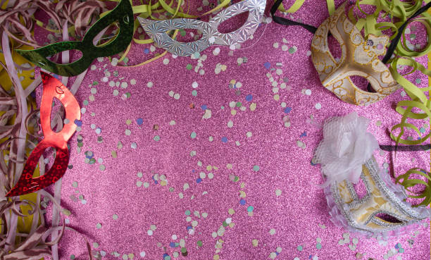 istock Brazilian carnival masks and props arranged on a shiny pink surface, top view. 1285248992