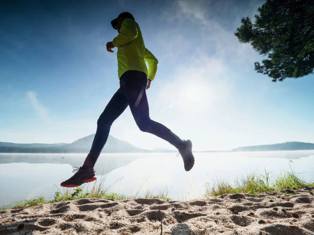 istock Slim man jogging on the beach early morning. 1285250989