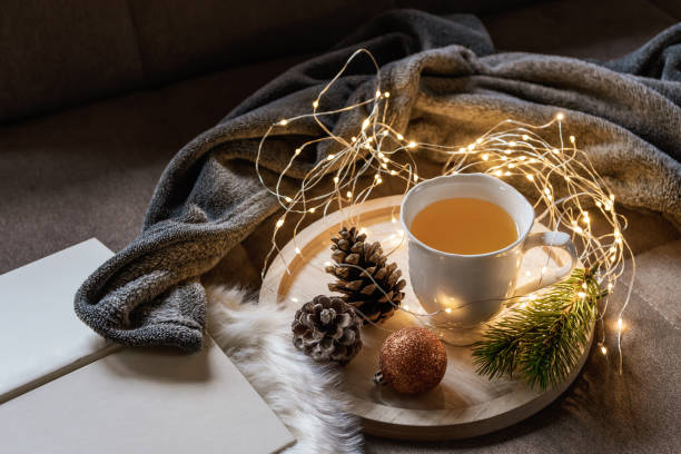 istock Tea break on a sofa with a string of lights and Christmas decorations 1285251132