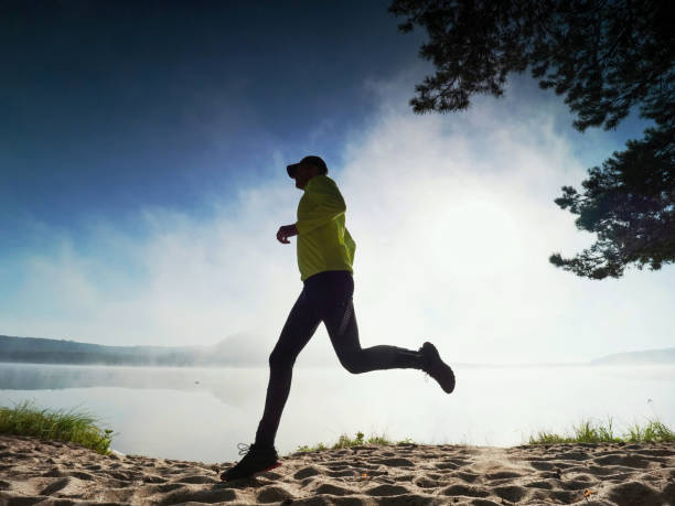 istock Caucasian man training on the beach in morning. 1285251230