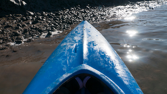 Blue kayak parked on the water's edge