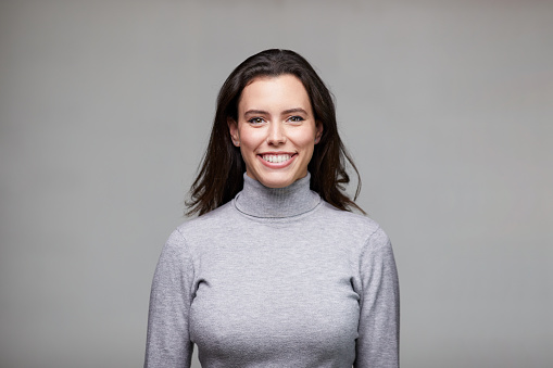 Portrait a young businesswoman wearing smiling at the camera.