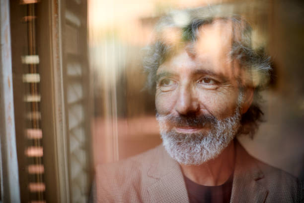 istock One man looking out of the window during lockdown due to coronavirus 1285253637